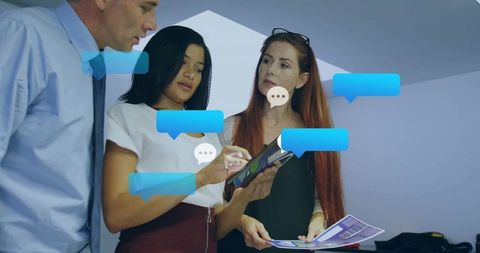 Diverse Colleagues Collaborating with Digital Interface in Office