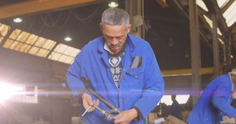 Biracial Male Mechanic Working in Industrial Workshop with Glowing Light - Download Free Stock Images Pikwizard.com