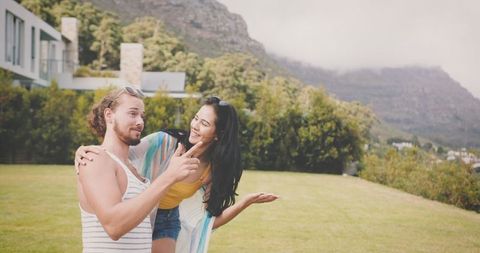 Playful Couple Enjoying Summer Outdoors in Lush Mountain Setting