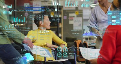 Diverse team analyzing financial holographic data in modern office