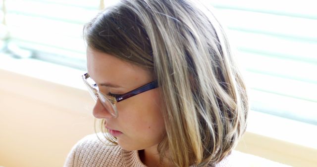 Contemplative Young Woman with Glasses at Home - Download Free Stock Images Pikwizard.com