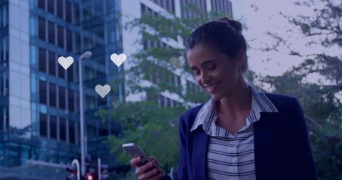Smiling Woman Engaged with Social Media Outdoors