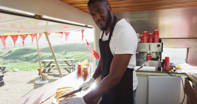 Smiling Street Food Vendor Preparing Hot Dogs in Food Truck - Download Free Stock Images Pikwizard.com