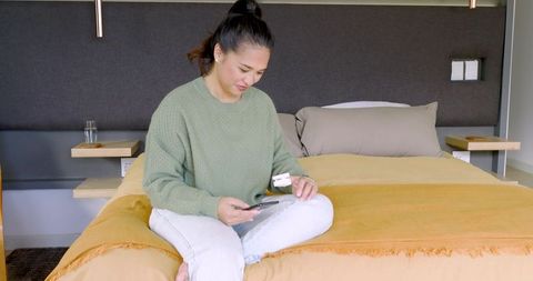 Woman in Modern Bedroom Integrating Technology with Comfort
