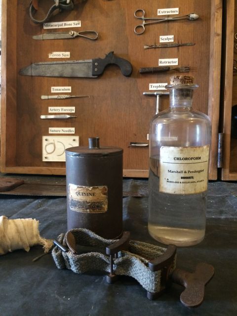 This image captures an arrangement of vintage medical tools and bottles with labels reading 'Quinine' and 'Chloroform.' Perfect for use in articles or presentations about the history of medicine, antique collections, or the evolution of medical practices. Students, educators, and historians will find this resource useful for illustrating historical medical conditions and treatments.
