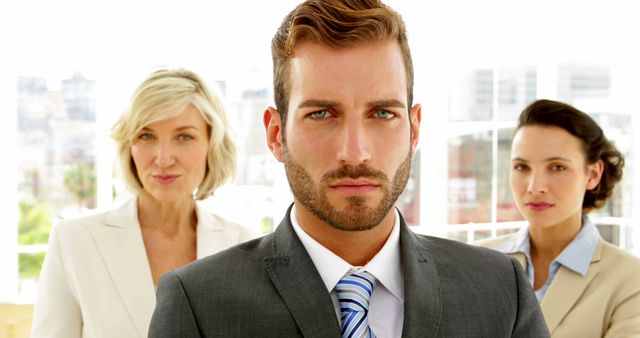 Confident Businessman Standing with Two Professional Businesswomen - Download Free Stock Images Pikwizard.com