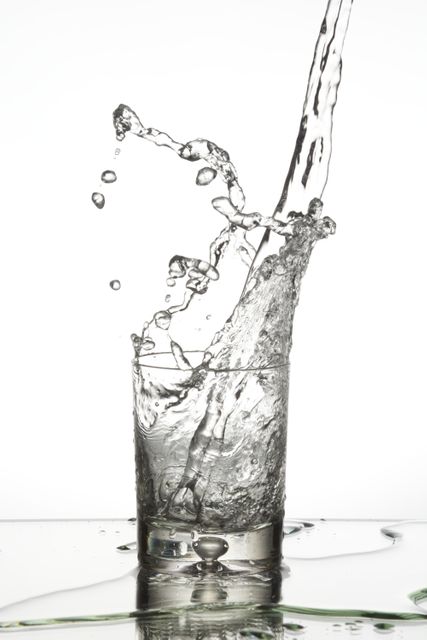 Water Splashing Into Glass on White Background - Download Free Stock Photos Pikwizard.com