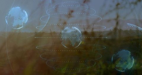 Holographic wireframe globes with dotted orbital rings over sunlit meadow landscape