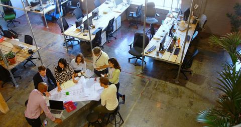 Diverse team meeting in open concept workspace