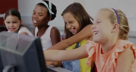 Group of Girls Collaborating on School Computer Project in Classroom