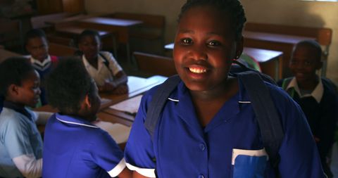 Smiling Student in Classroom Highlighting Joy of Education