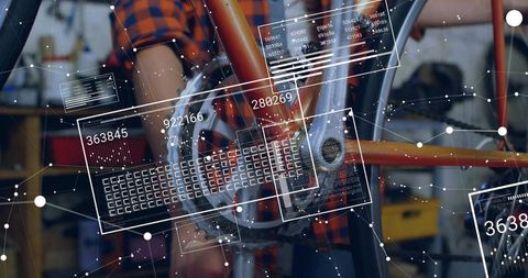 Inspecting mechanic adjusting bicycle drivetrain with augmented reality hud in workshop