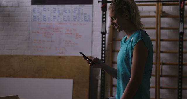 Athletic Woman Checking Smartphone during Workout in Gym - Download Free Stock Images Pikwizard.com