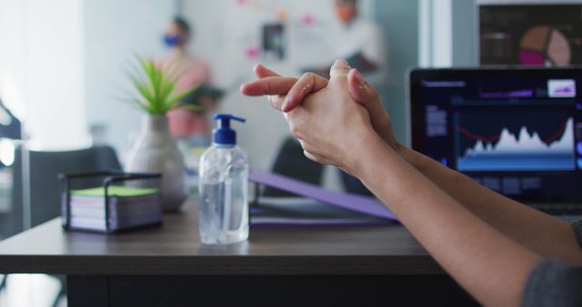 Woman Disinfecting Hands in Modern Office Environment - Download Free Stock Images Pikwizard.com