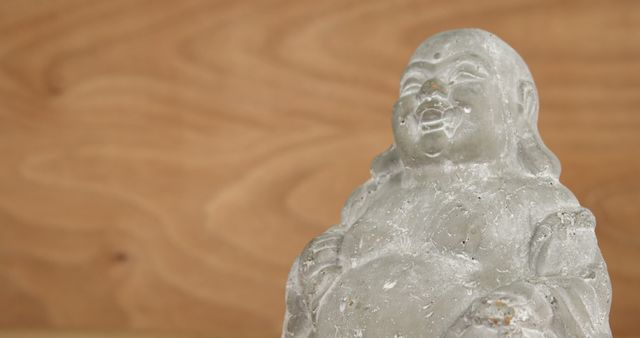 Close-up of Grey Buddha Statue on Wooden Background - Download Free Stock Images Pikwizard.com