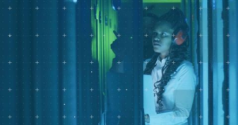 Technician Observing Server Infrastructure with Grid Overlay