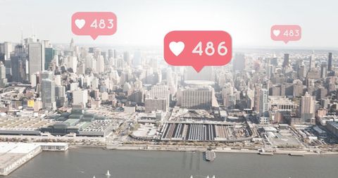 Social Media Engagement Icons Floating Above Urban Cityscape