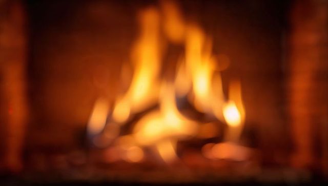 Flickering Fireplace Flames Creating Warm Bokeh and Cozy Amber Hearth Ambience