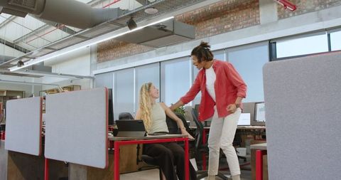 Colleagues Having Fun Pushing Chair in Modern Office