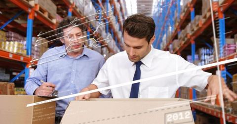 Inspecting warehouse inventory during logistics audit, supervisor and team checking boxes