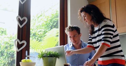 Couple Collaborating on Laptop in Bright Modern Home Office