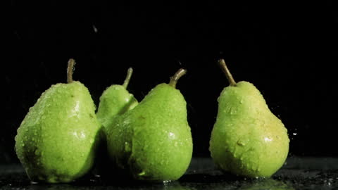 Fresh Green Pears with Water Droplets on Black Background