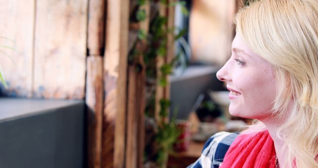 Smiling Woman with Blonde Hair Looking Away in a Rustic Coffee Shop - Download Free Stock Images Pikwizard.com