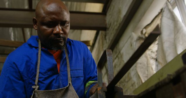 African Carpenter Concentrating on Woodwork in Rustic Workshop - Download Free Stock Images Pikwizard.com