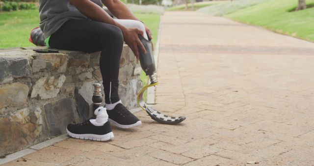 Paralympic Athlete Adjusting Running Blade Prosthetic Leg Outdoors - Download Free Stock Images Pikwizard.com