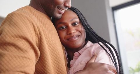 Romantic African American Couple Embracing by Window