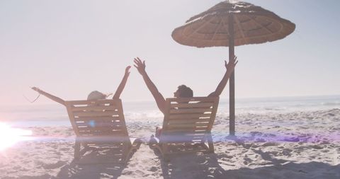 Couple Relaxing in Beach Chairs Enjoying Sunny Day