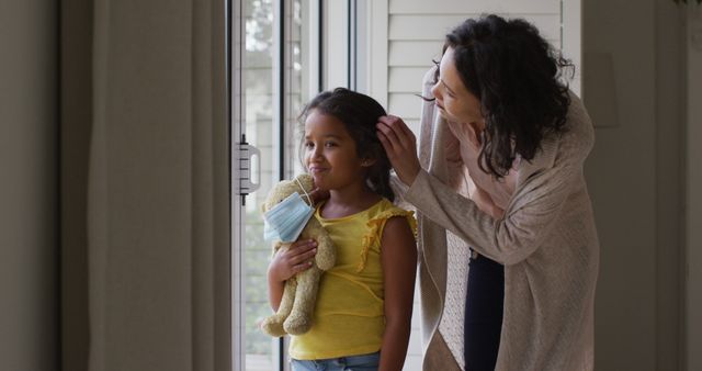 Mother Helping Daughter Get Ready While Holding Stuffed Toy at Home - Download Free Stock Images Pikwizard.com