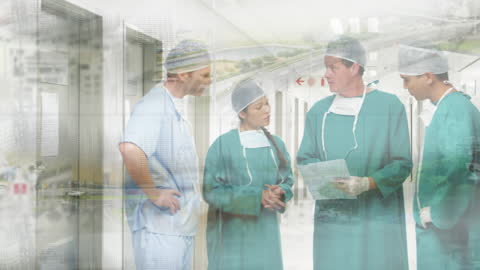 Medical Team Discussing Data in Hospital Corridor