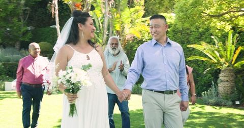 Senior Couple Celebrating Wedding with Friends in Sunny Garden