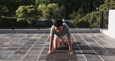 Asian man preparing for exercise on rooftop terrace