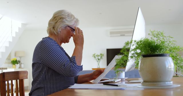 Senior Woman Reading Documents at Home Office Desk - Download Free Stock Images Pikwizard.com