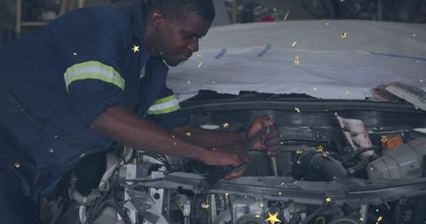 African american mechanic repairing car engine in garage workshop using wrench and tools
