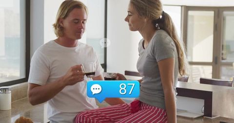 Couple Enjoying Morning Coffee in Modern Kitchen With Social Media Icon