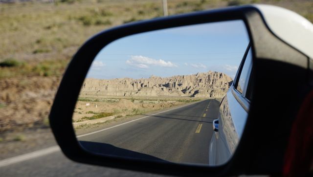 Rocky Landscape Reflected in Car Side Mirror on Deserted Road - Download Free Stock Photos Pikwizard.com