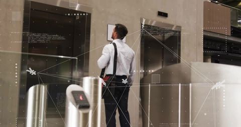 Professional man waiting at elevator in modern office lobby