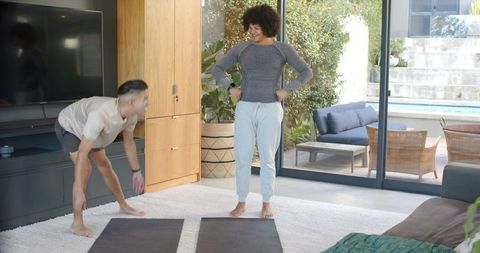 Diverse Male Workout Partners Exercising in Modern Living Room