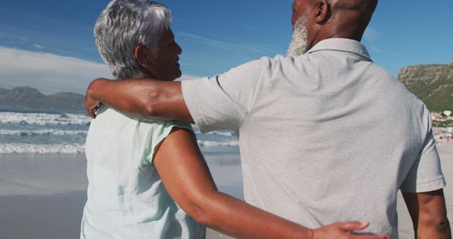 Senior african american couple embracing at the beach. healthy outdoor leisure time by the sea.