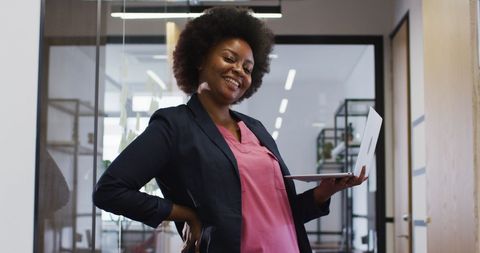 African American Businesswoman Smiling with Laptop in Modern Office - Download Free Stock Images Pikwizard.com
