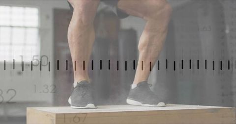 Mid-adult male strengthening calves on plyo box in sunlit gym with measurement overlay