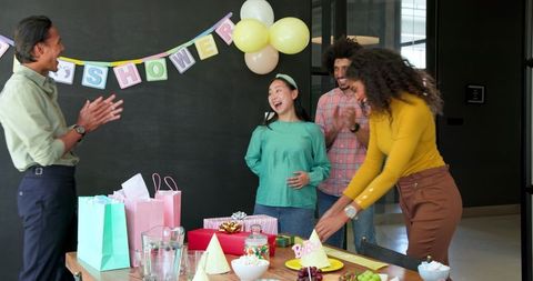 Colleagues Celebrating Baby Shower in Office, Sharing Joy and Laughter