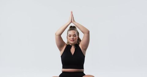 Confident Plus-Size Woman Practicing Meditation with Closed Eyes