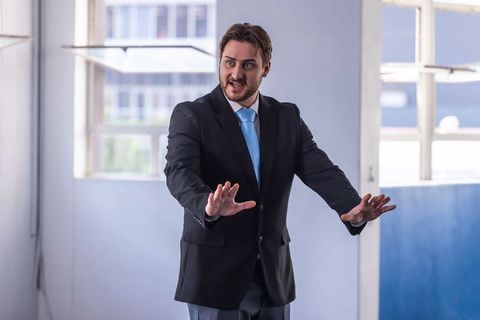 Business Leader Addressing Colleagues in Modern Office Room