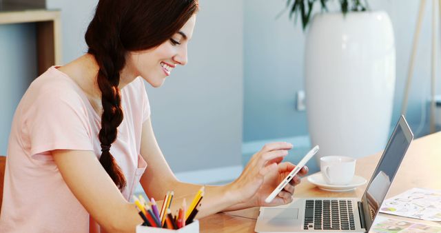 Young Woman Working on Laptop and Smartphone in Modern Home Office - Download Free Stock Images Pikwizard.com