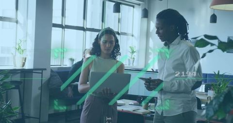 Diverse professionals collaborating with technology in modern open office
