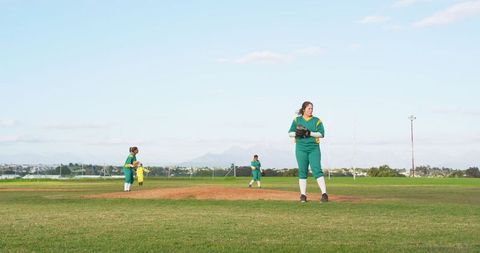 Female softball pitcher displaying skill on mound